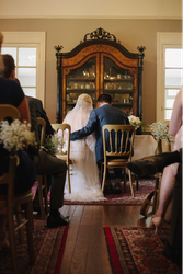 Bride and Groom sat at alter