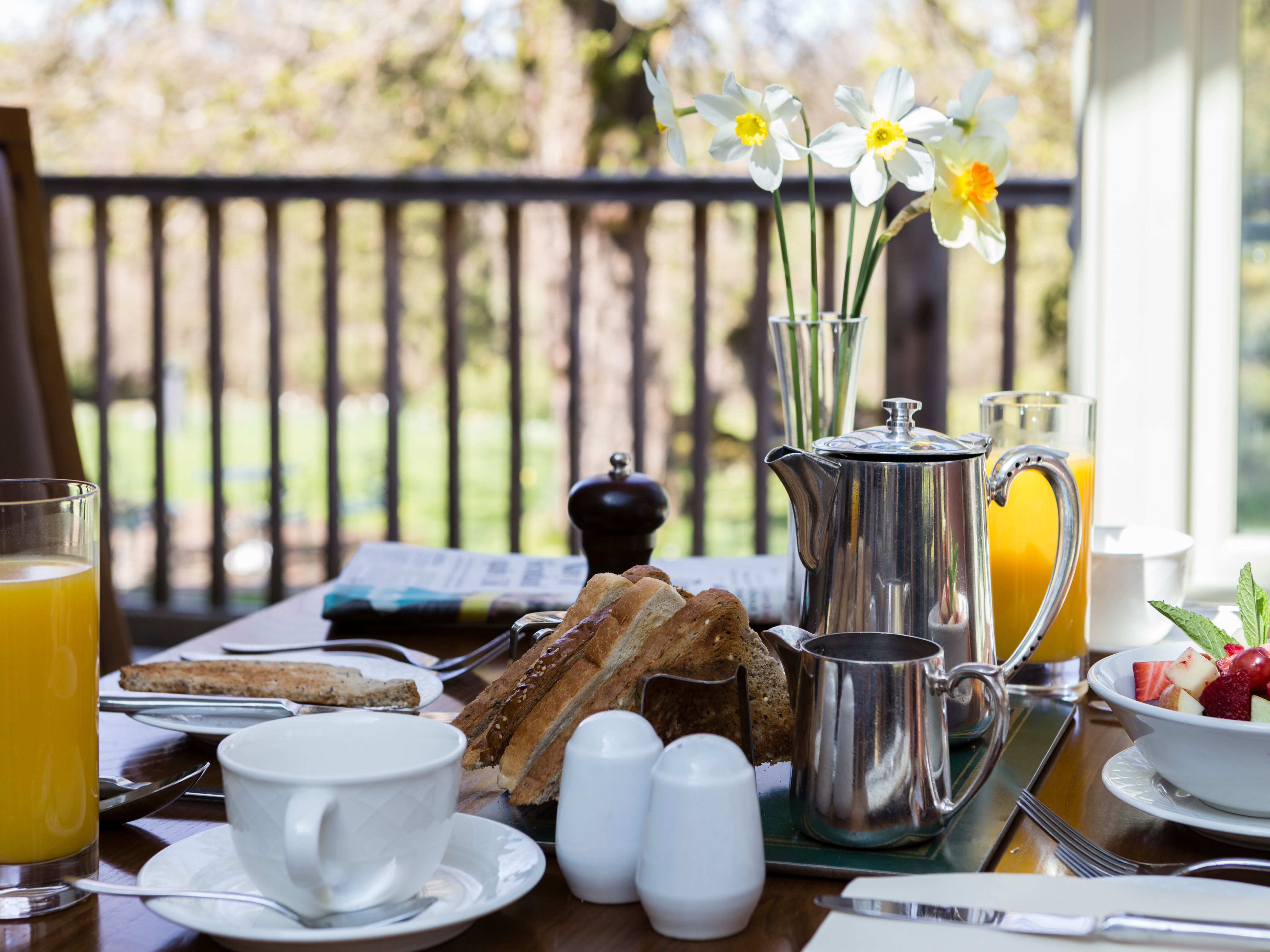 Selection of breakfast items laid out on outdoor table