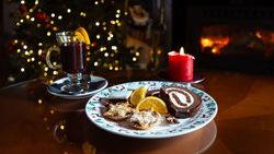 Plate filled with Christmas treats and a glass of mulled wine