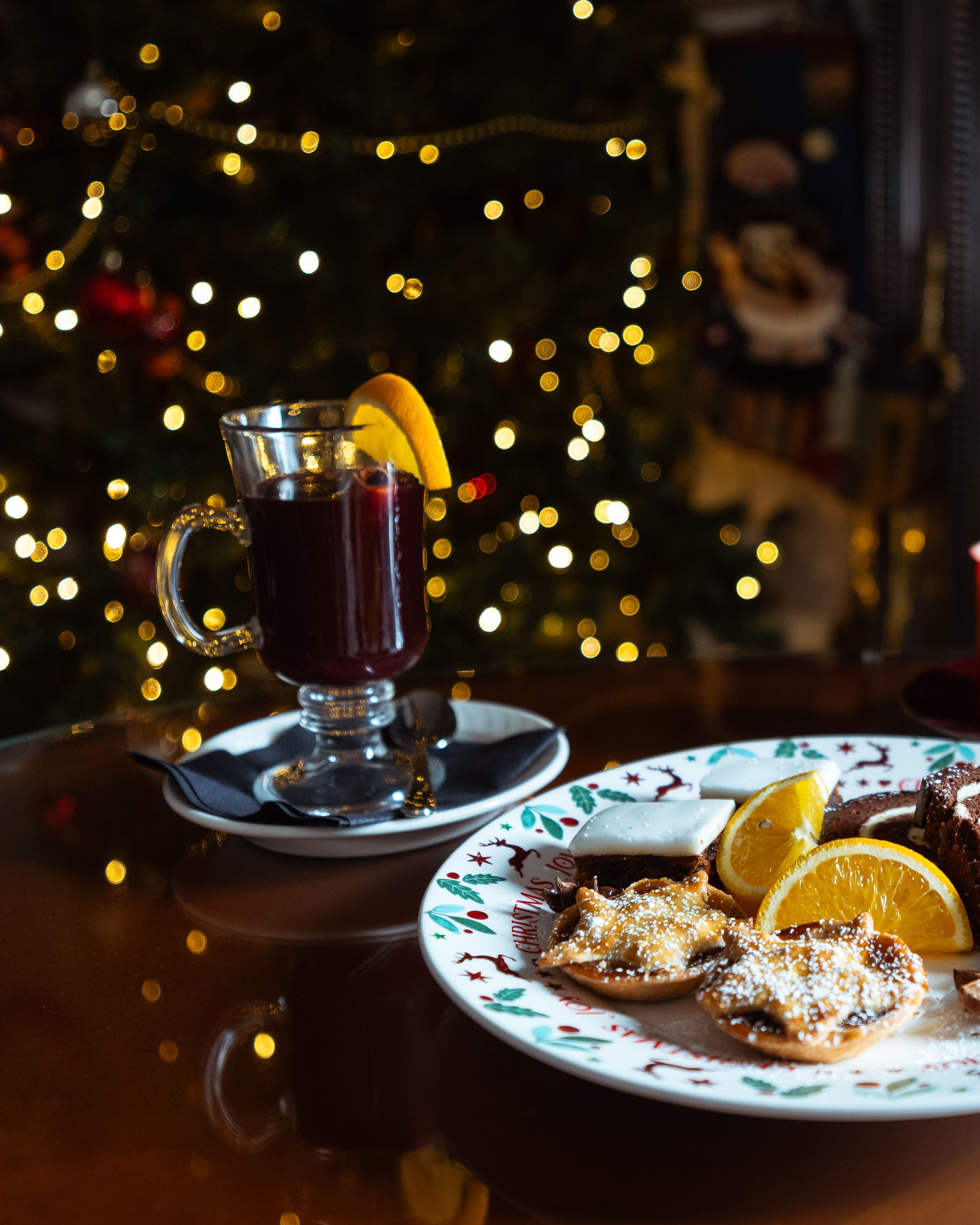 Plate filled with Christmas treats and a glass of mulled wine
