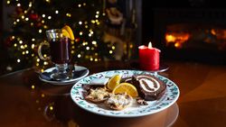 Plate filled with Christmas treats and a glass of mulled wine
