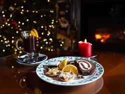 Plate filled with Christmas treats and a glass of mulled wine