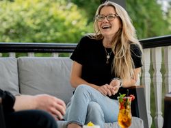 Lady with two cocktails laughing