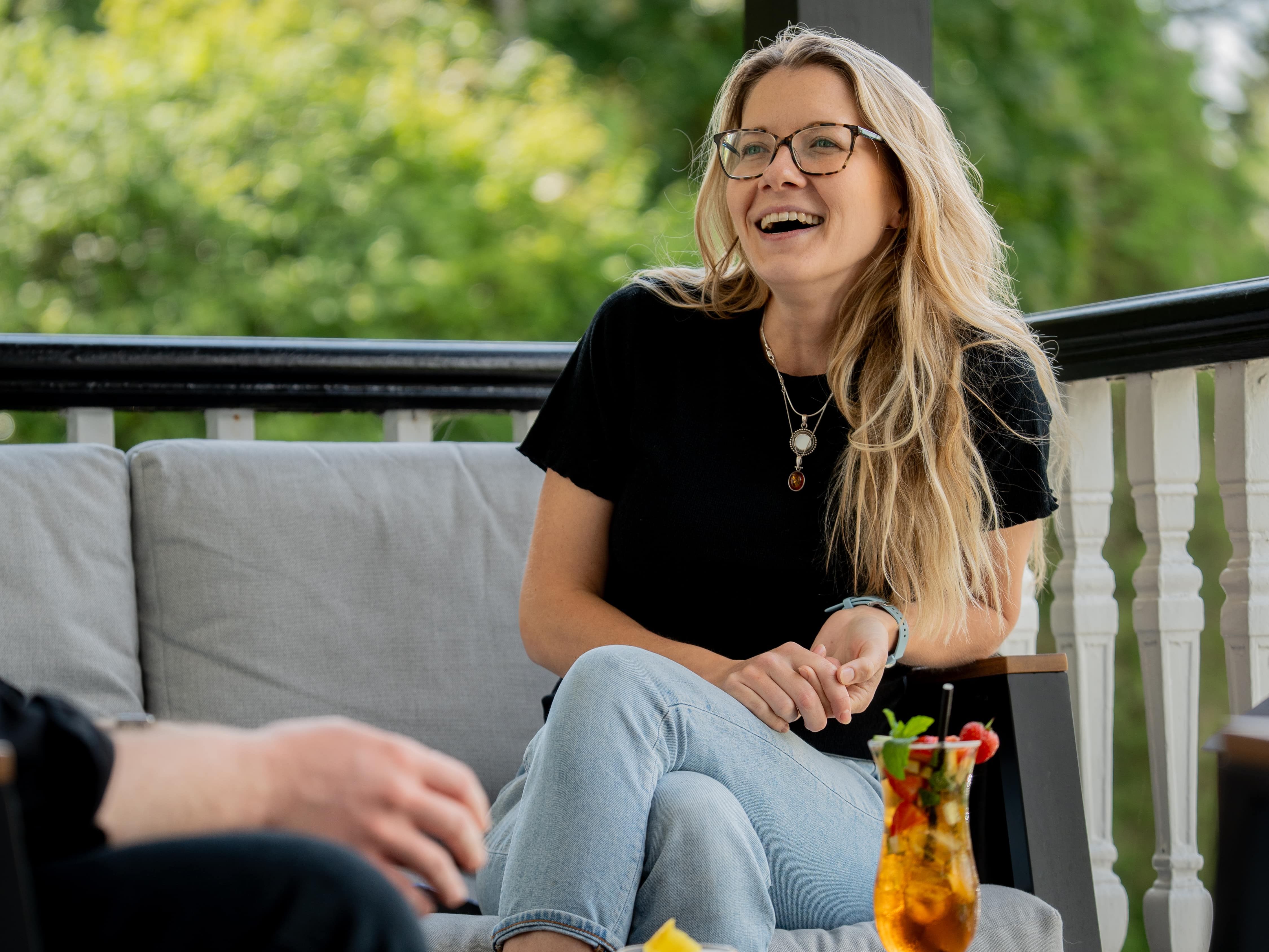 Lady with two cocktails laughing