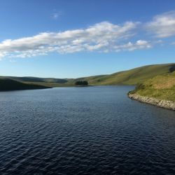 Welsh reservoir with large body of water against green grass
