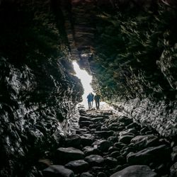 People walking through an enclosed cave