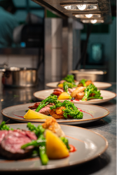 Afew plates of food lined up on a food pass