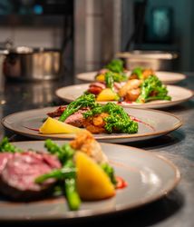 Afew plates of food lined up on a food pass
