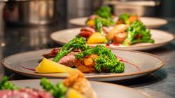 Afew plates of food lined up on a food pass