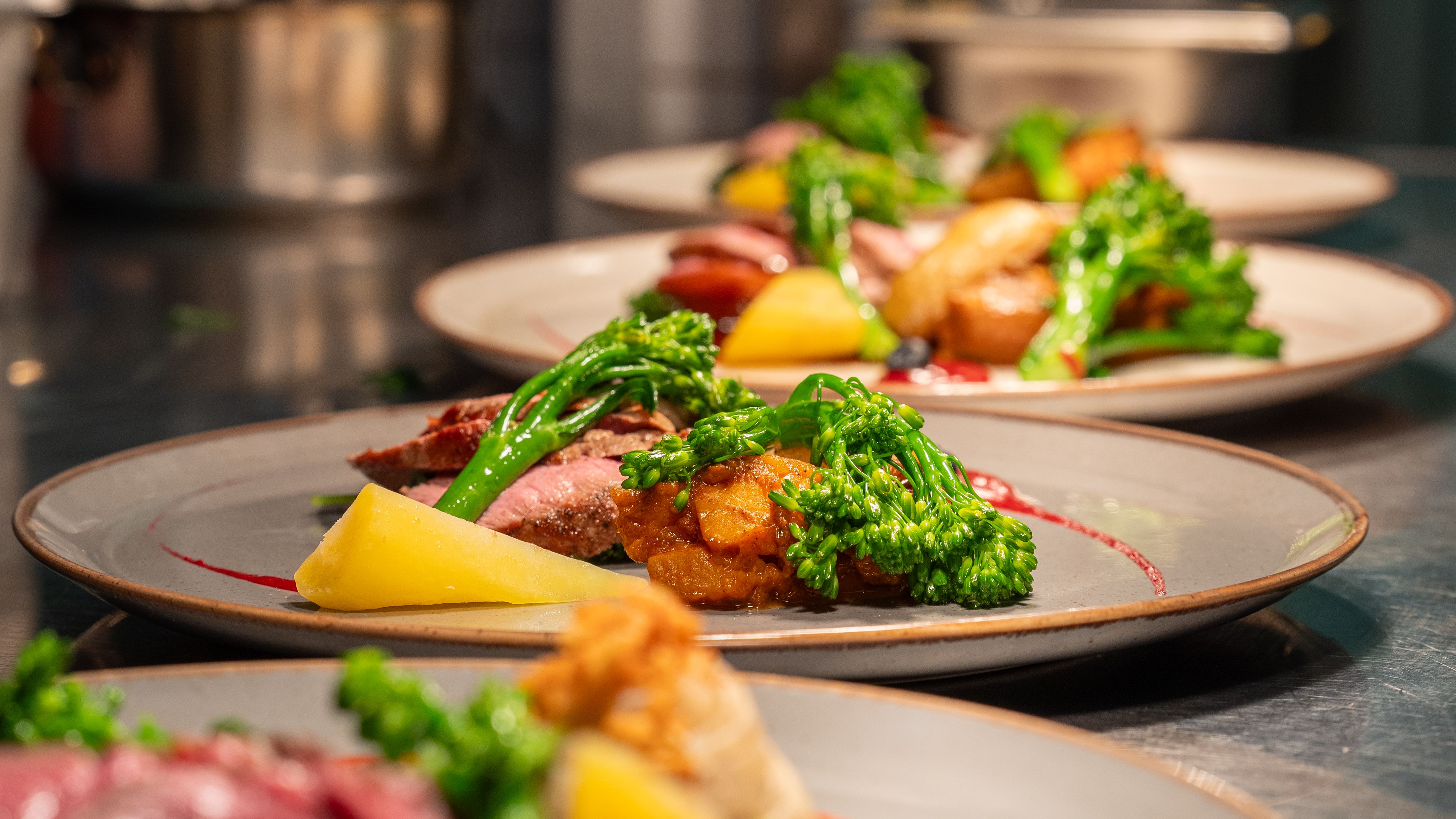 Afew plates of food lined up on a food pass