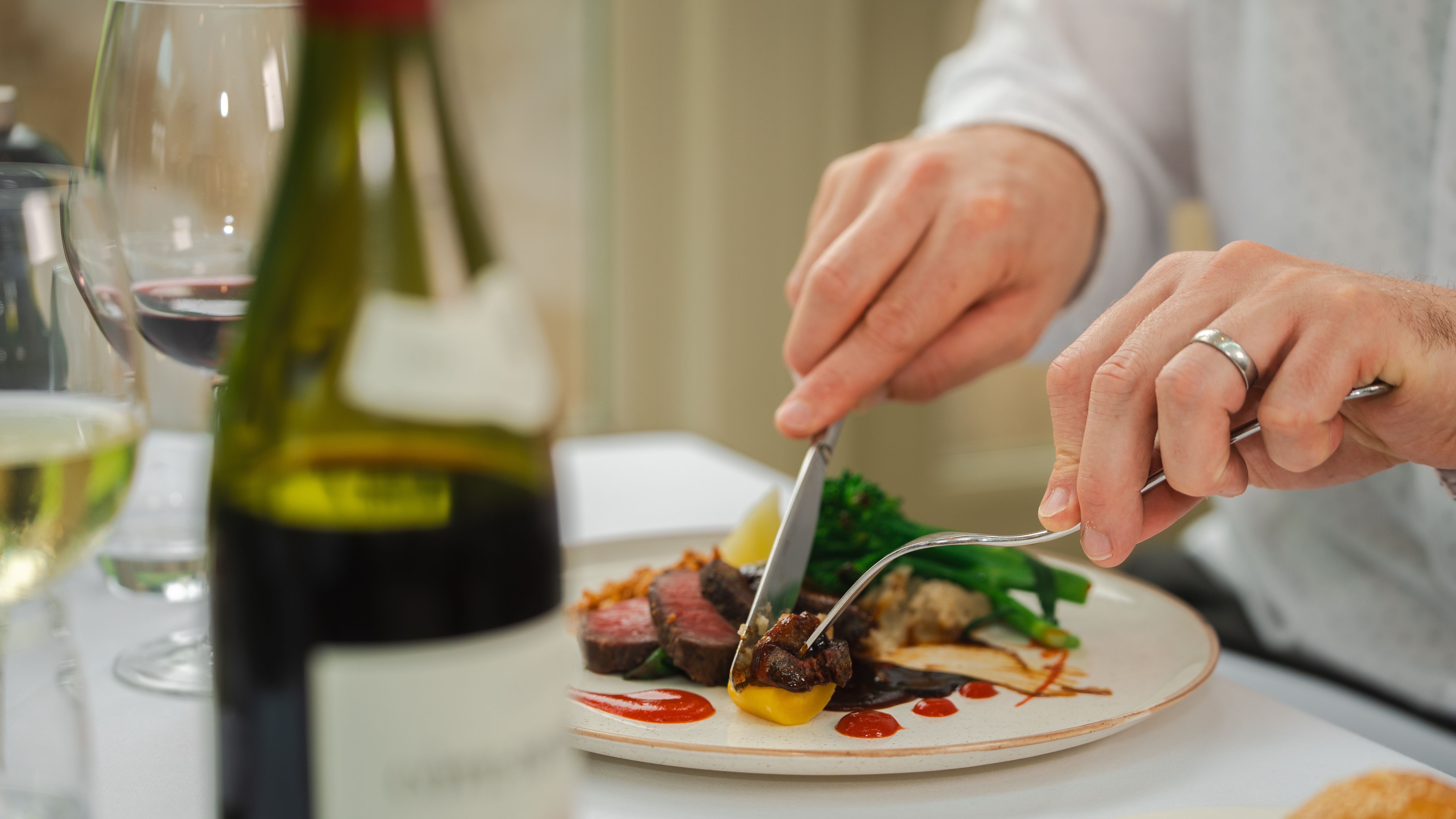 Man cutting into his food