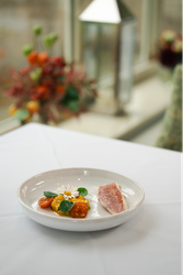 A plate of neatly presented fish and vegetables