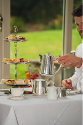 Cake stand next to silver tea set