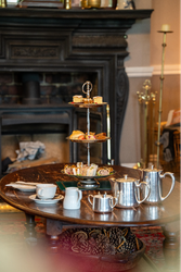 Cake stand next to silver tea set