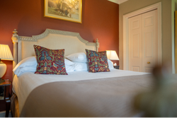 Double bed in room with red walls