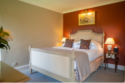 Double bed in room with red walls