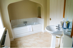 Bathroom with bathtub within the wall and sink