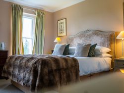 Bed with tartan blanket