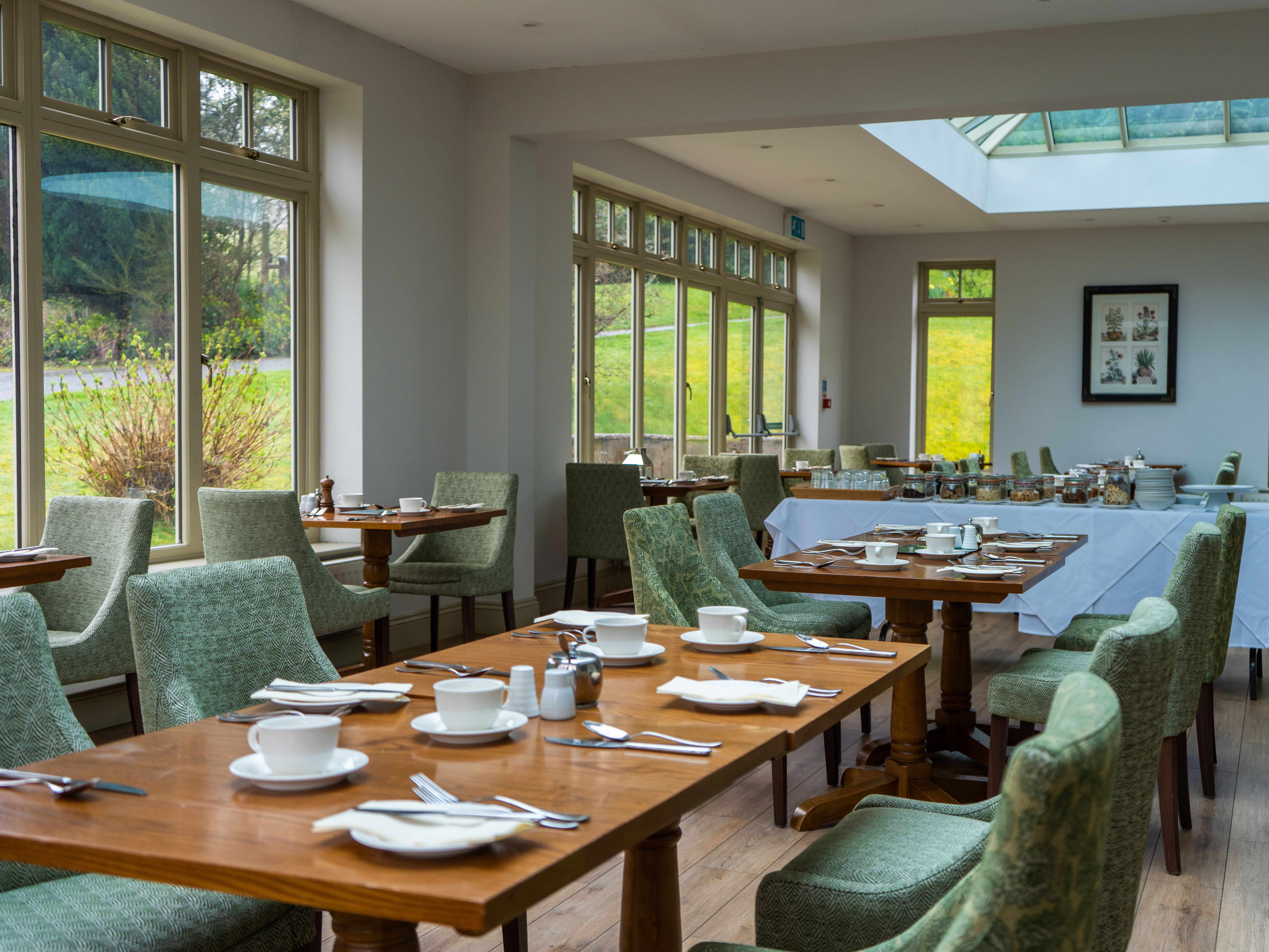 Dining table laid out with plates and cutlery