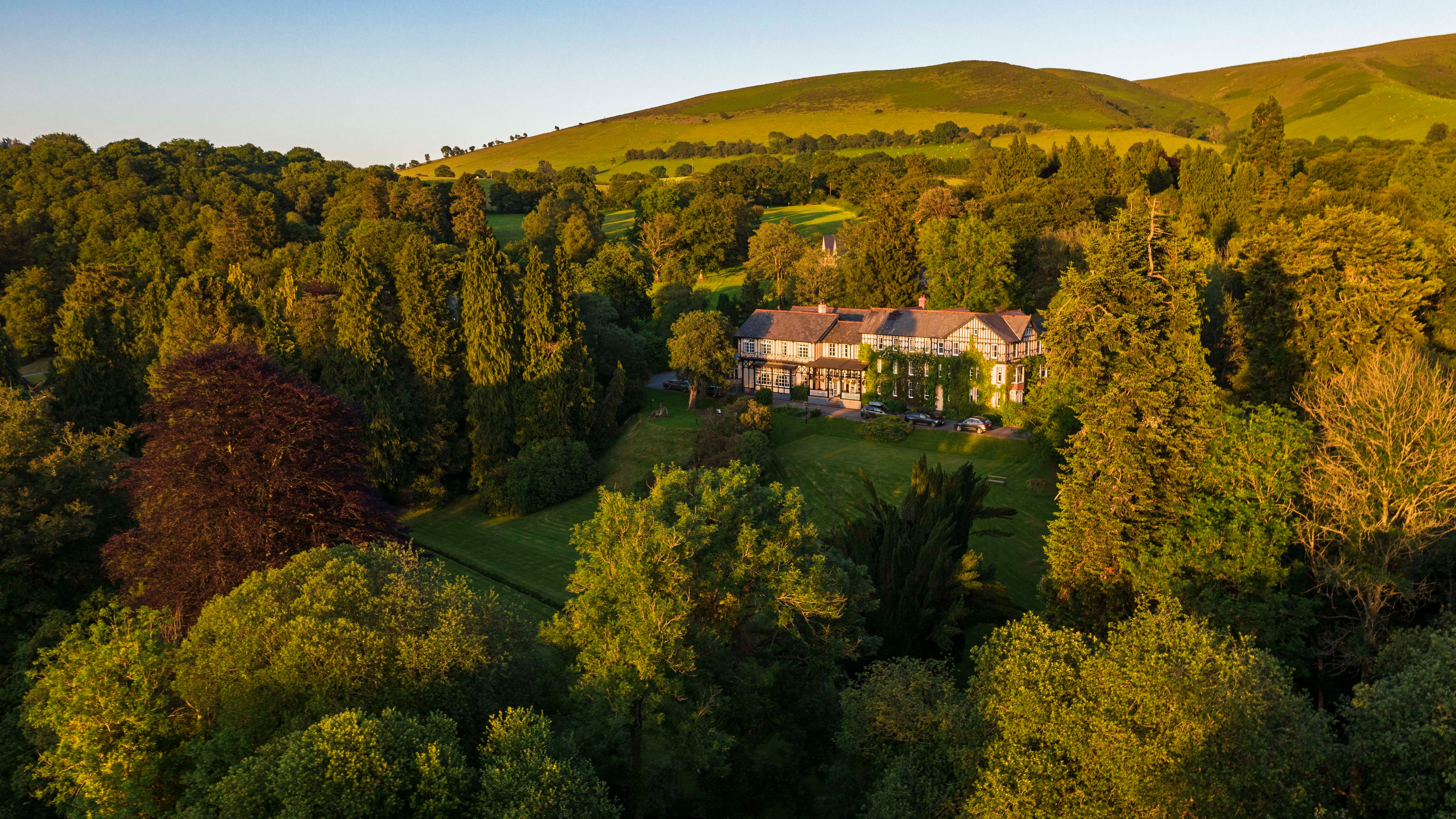 Exterior view of Lake Hotel surrounded by greenery