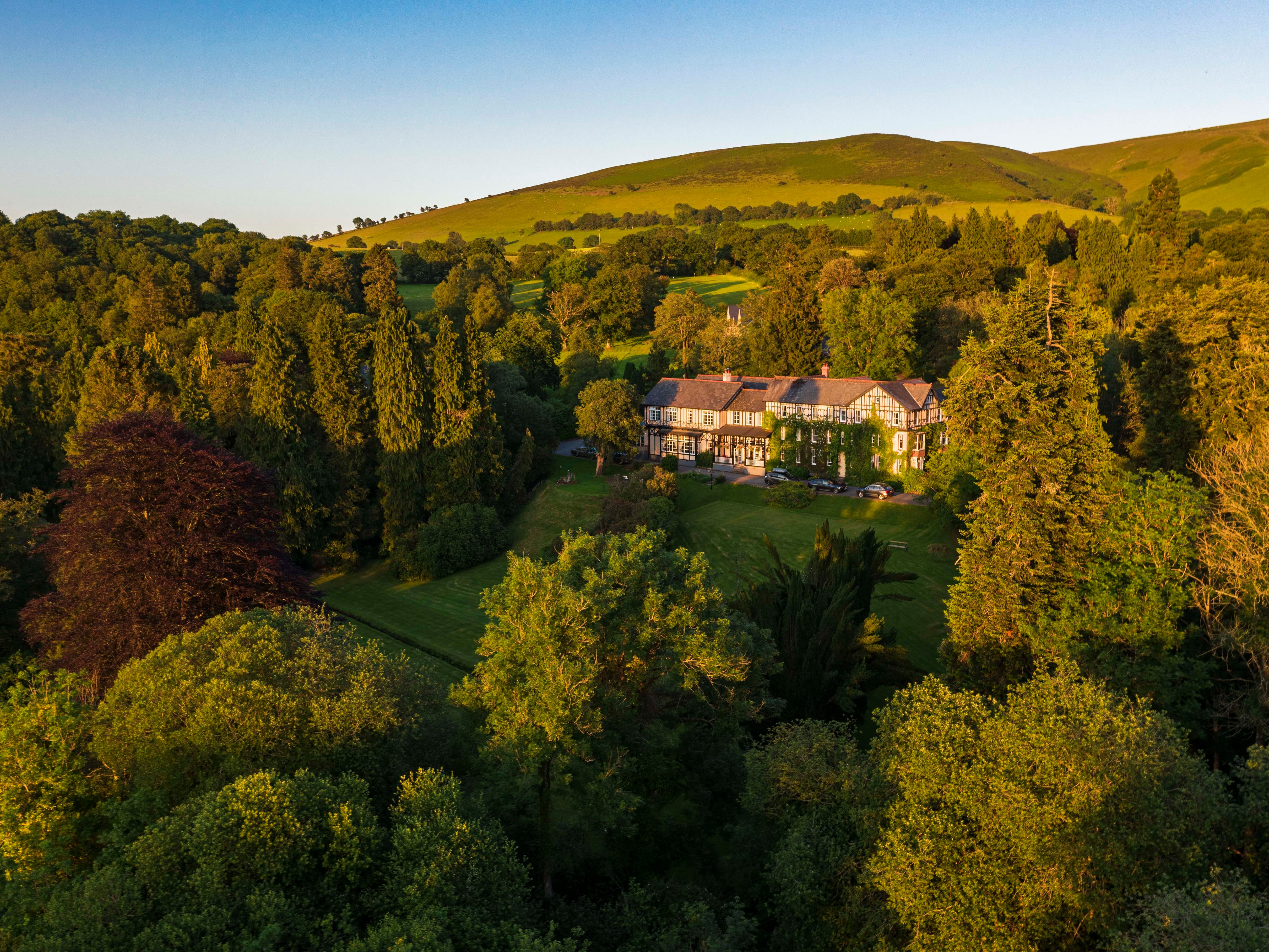 Exterior view of Lake Hotel surrounded by greenery