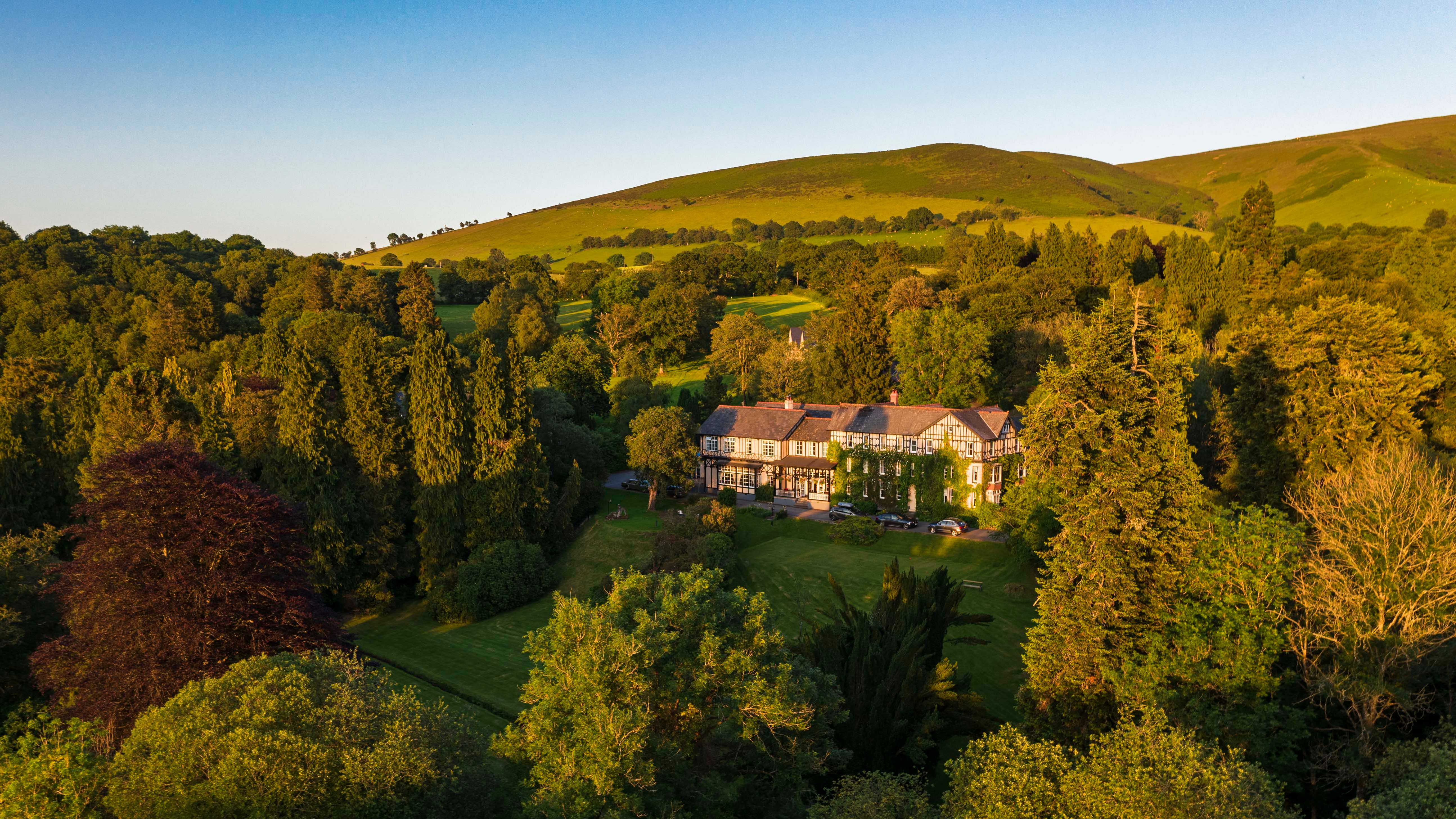 Exterior view of Lake Hotel surrounded by greenery
