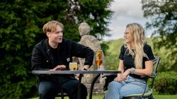 Two people drinking refreshing drinks and laughing