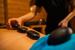 Lady Having a hot stone massage in the spa