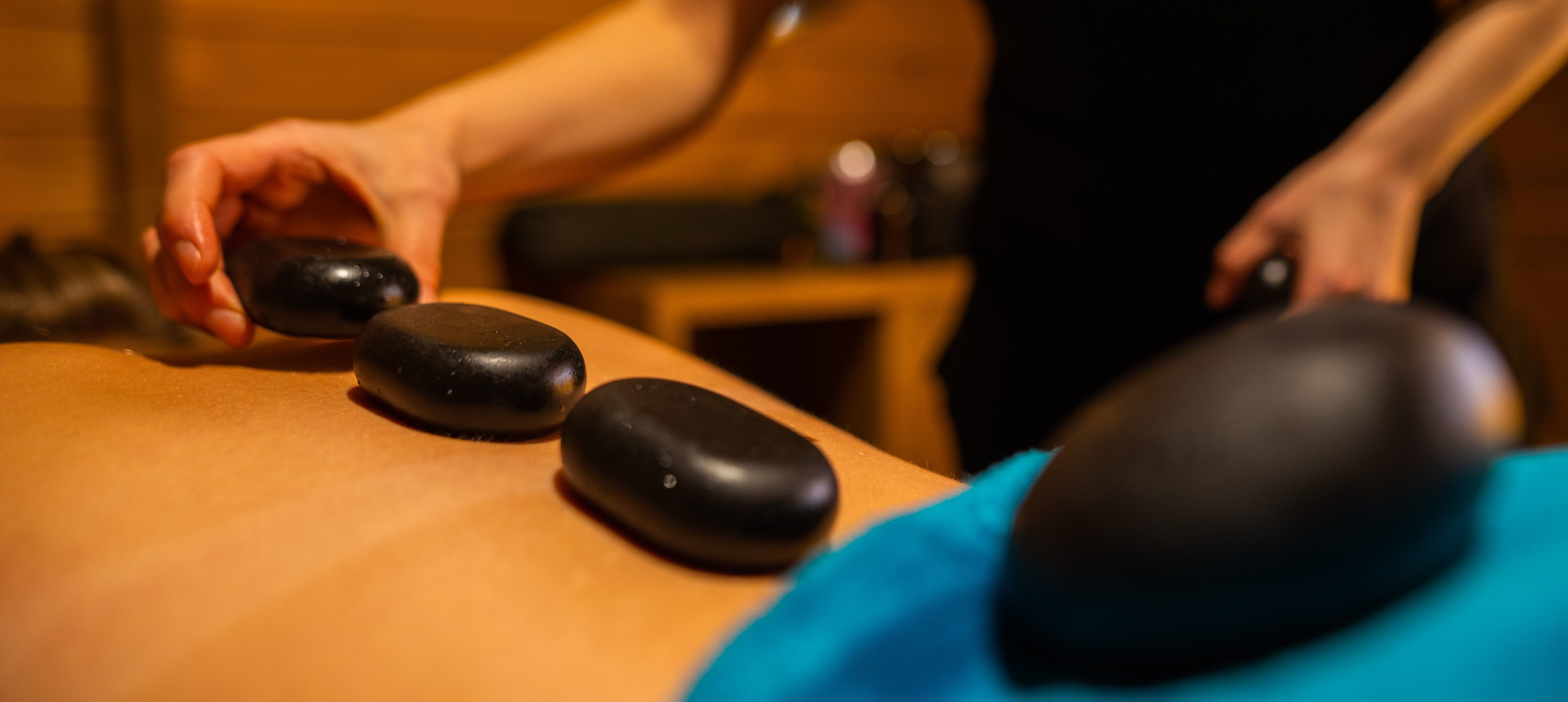 Lady Having a hot stone massage in the spa