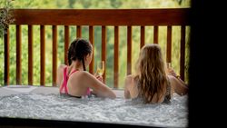 Two People enjoying a glass of prosecco in a hot tub