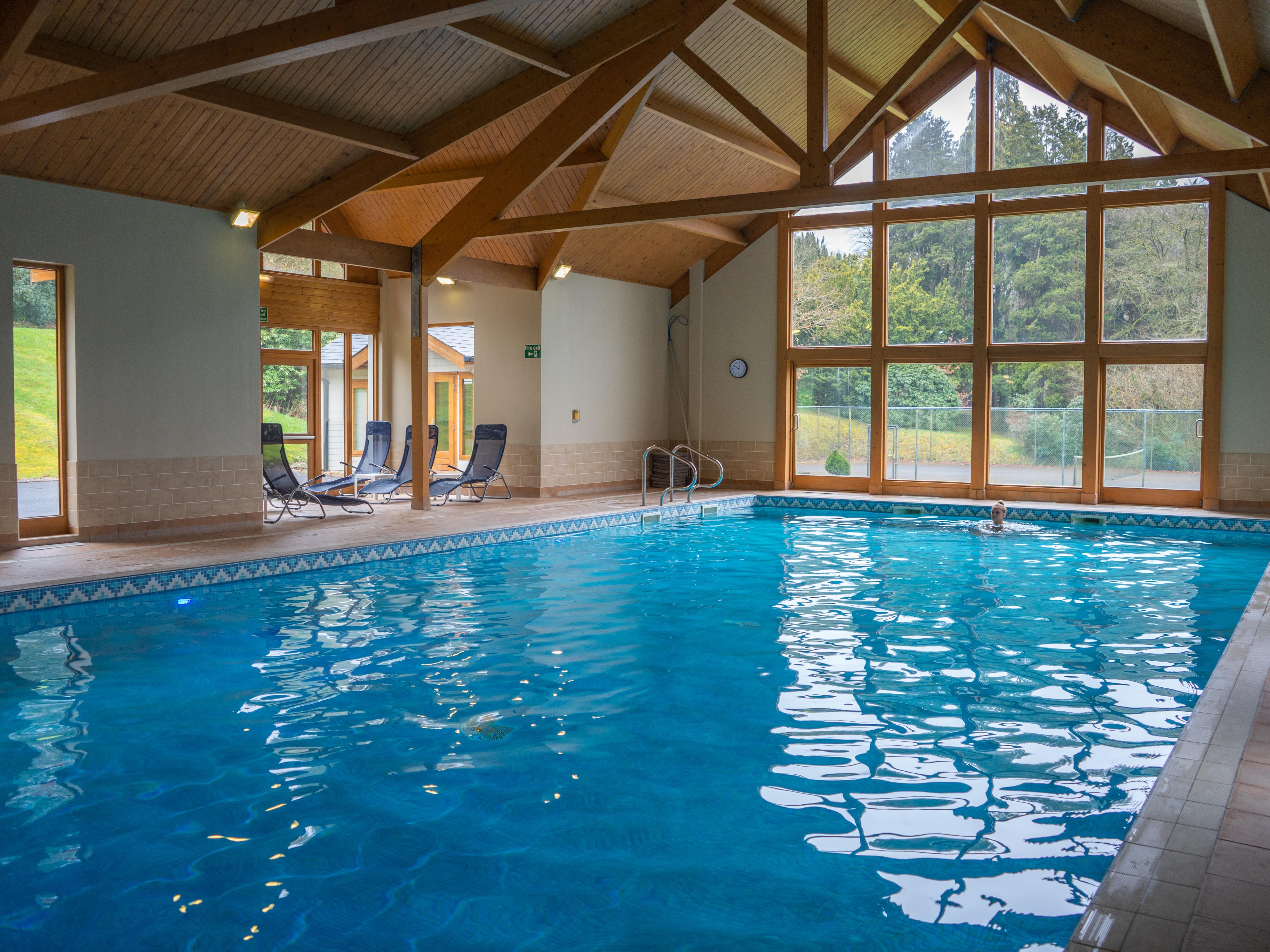Wide angle of swimming pool with window behind