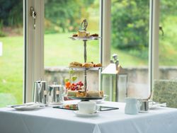 Afternoon tea on top of a white table in front of window