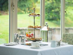 Afternoon tea on top of a white table in front of window