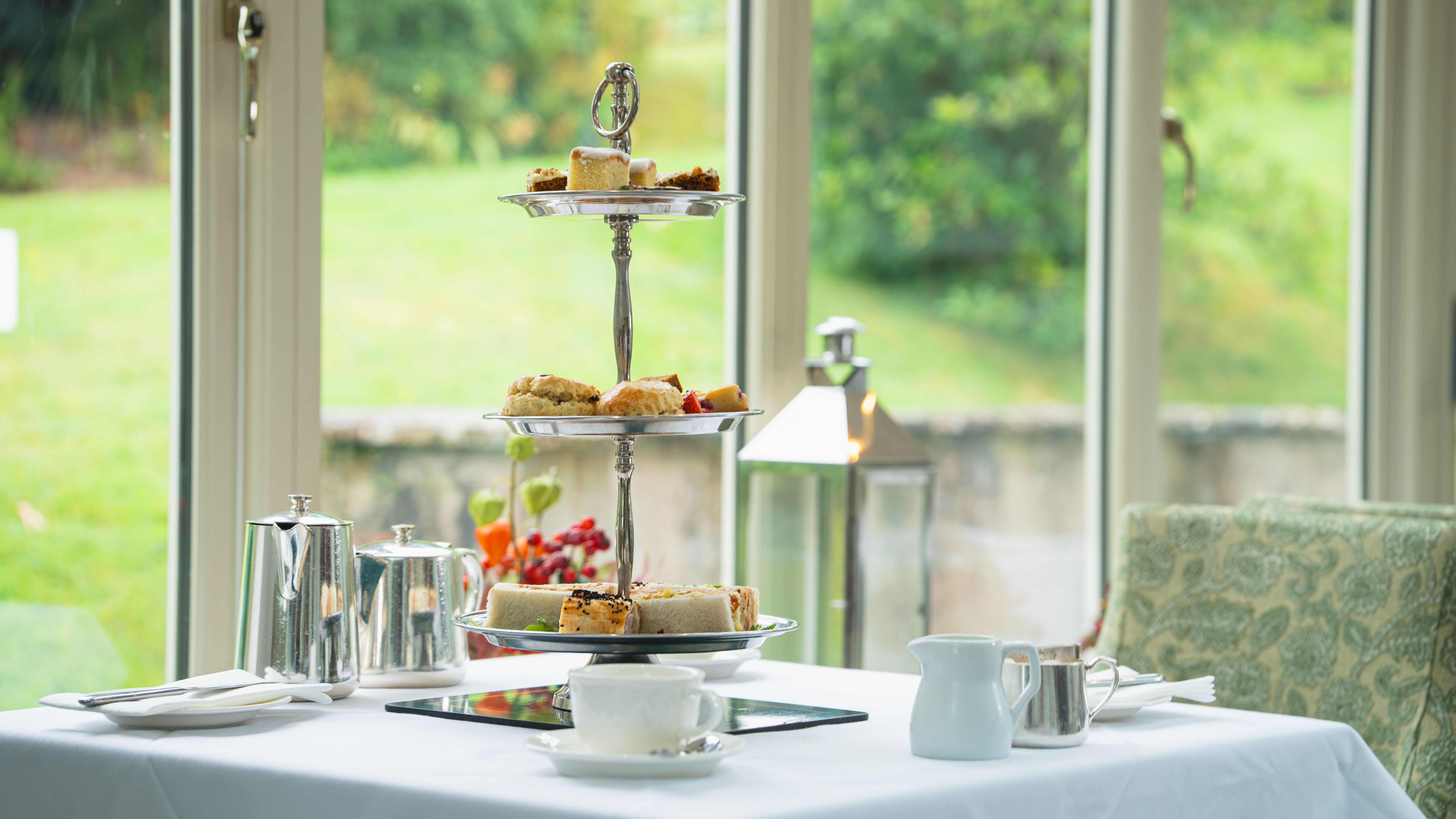 Afternoon tea on top of a white table in front of window