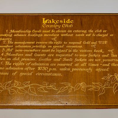 Wooden plaque displaying rules for Lakeside Country Club.
