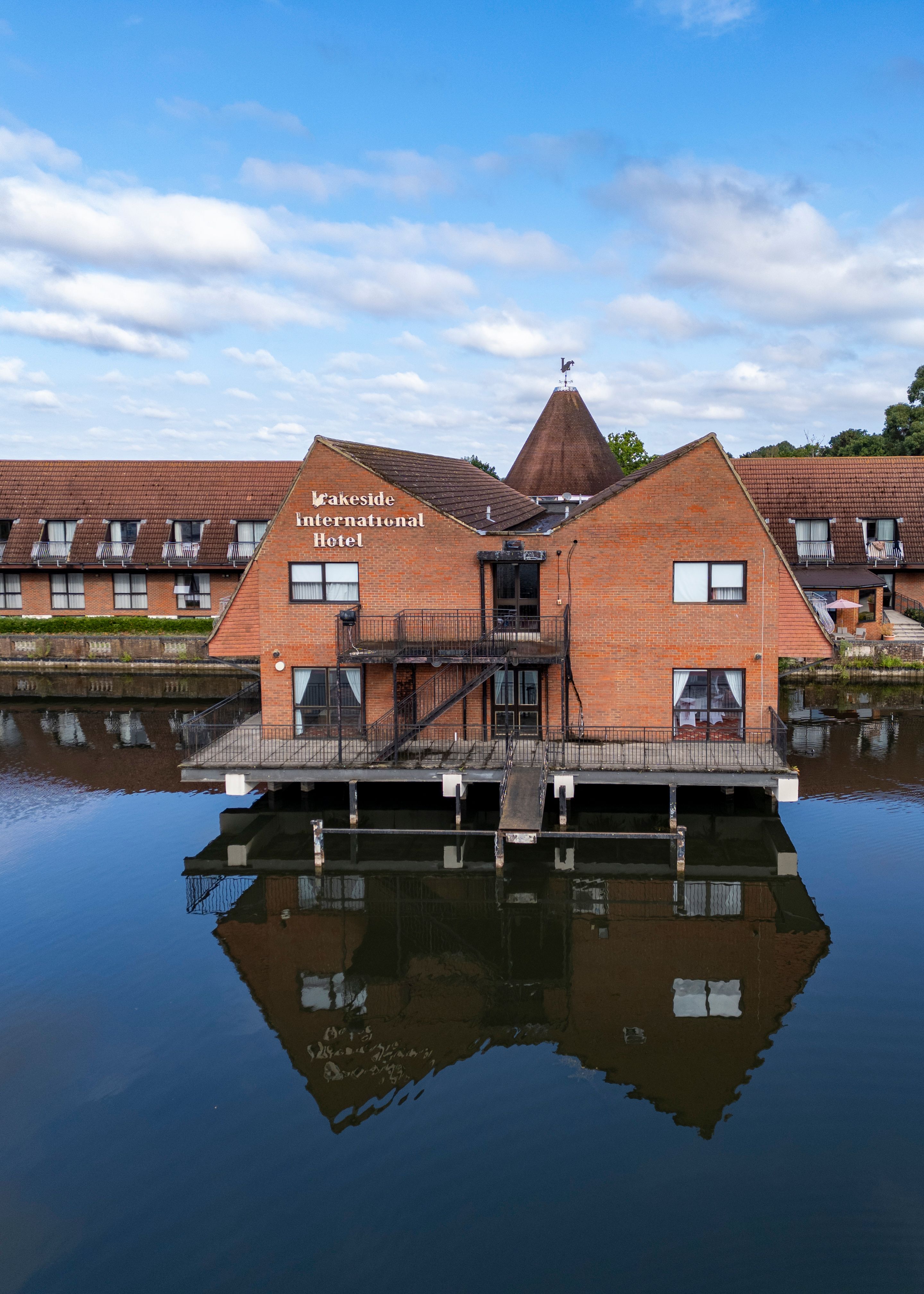 Lakeside International Hotel building over water with clear reflection