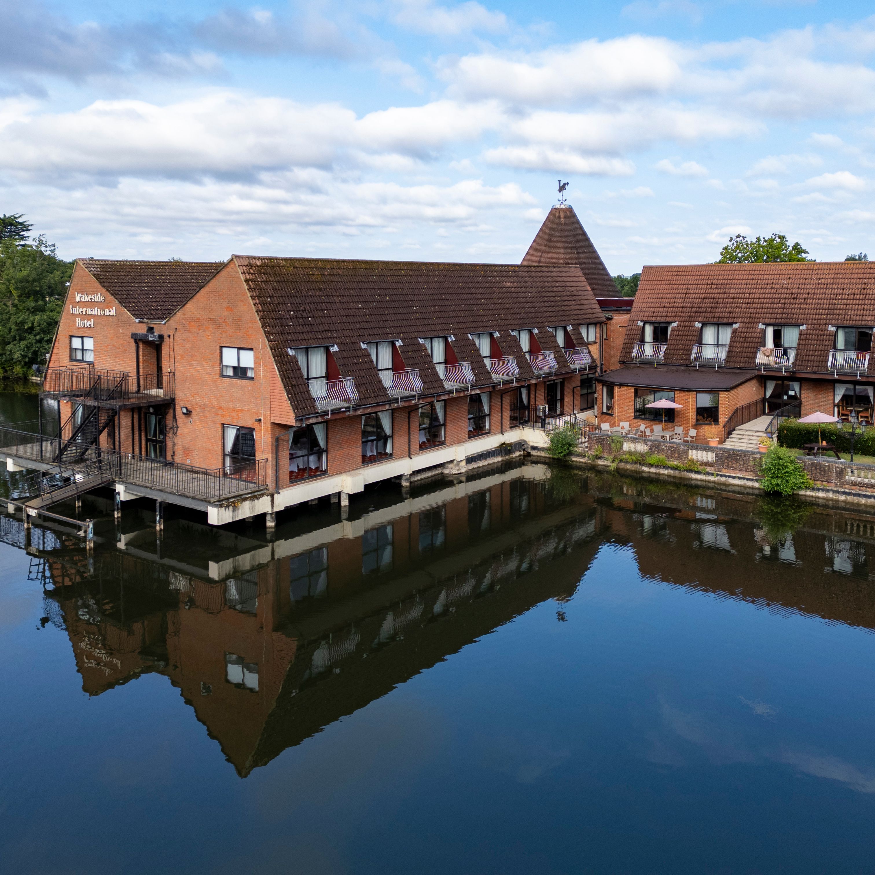 Lakeside International Hotel building with its reflection in the water