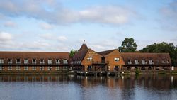 Lakeside International Hotel building beside a lake with reflections in the water