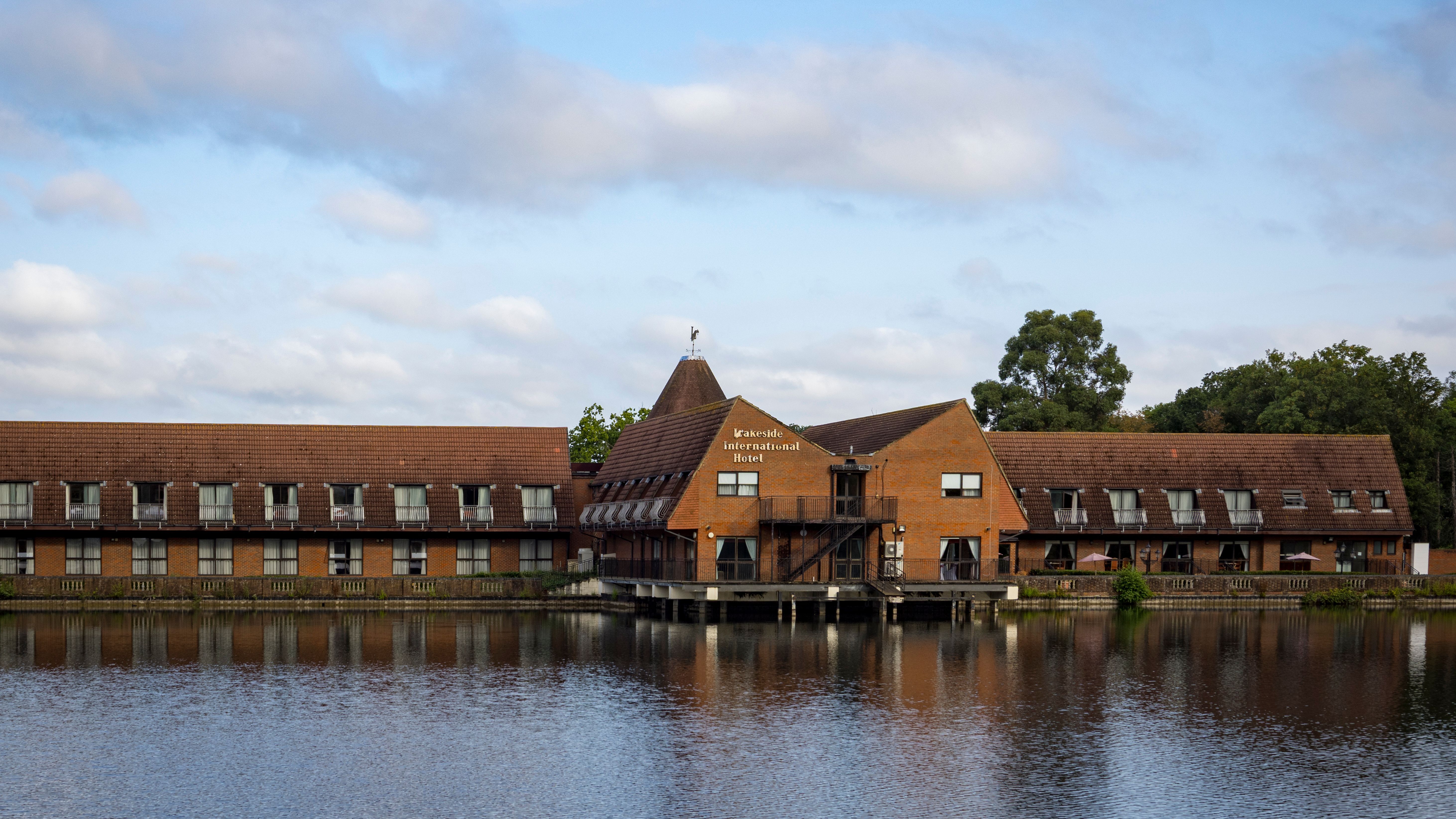 Lakeside International Hotel building beside a lake with reflections in the water
