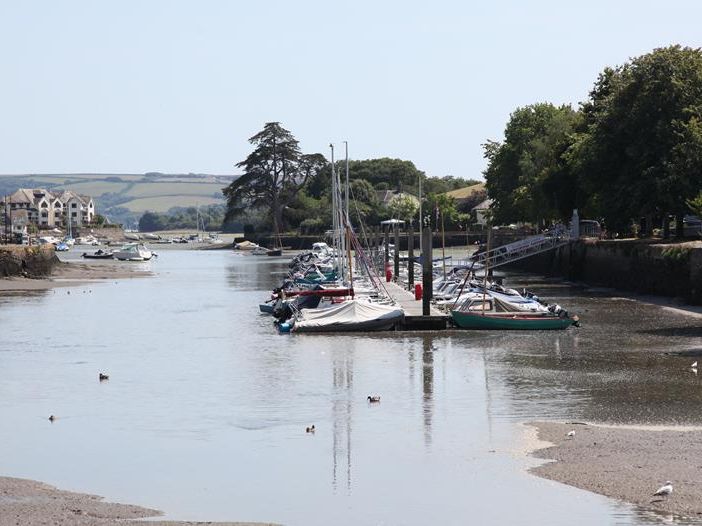 Sailboats moored on the River Kingsbridge at low tide