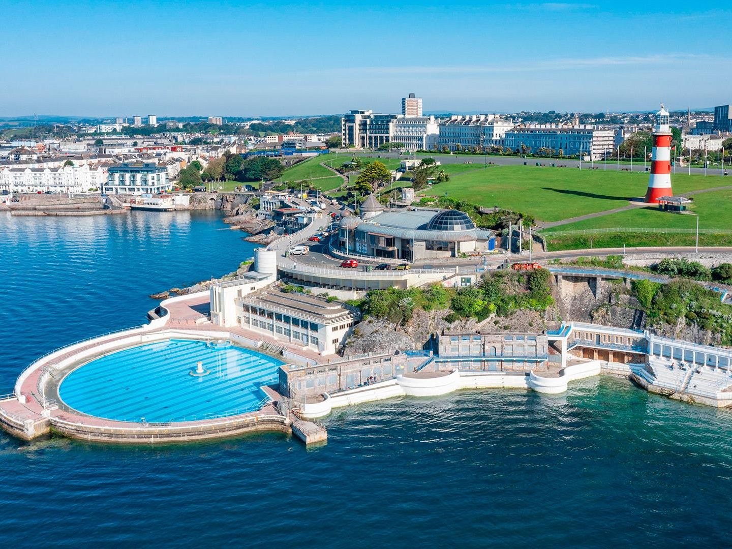 Aerial view of Plymouth Hoe with the Tinside Lido seawater pool and red-and-white Smeaton’s Tower overlooking Plymouth Sound