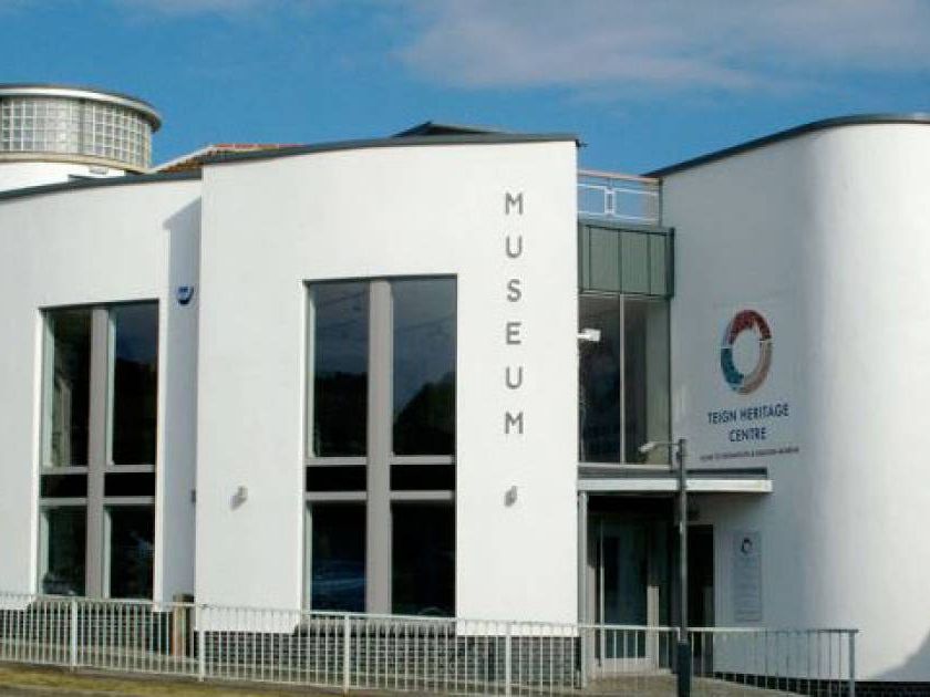 Exterior of the Teign Heritage Centre museum building with white curved walls and tall windows