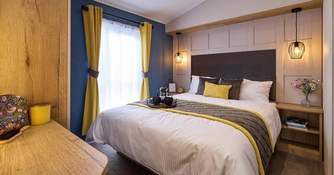 Modern bedroom with double bed, mustard curtains, and pendant lights