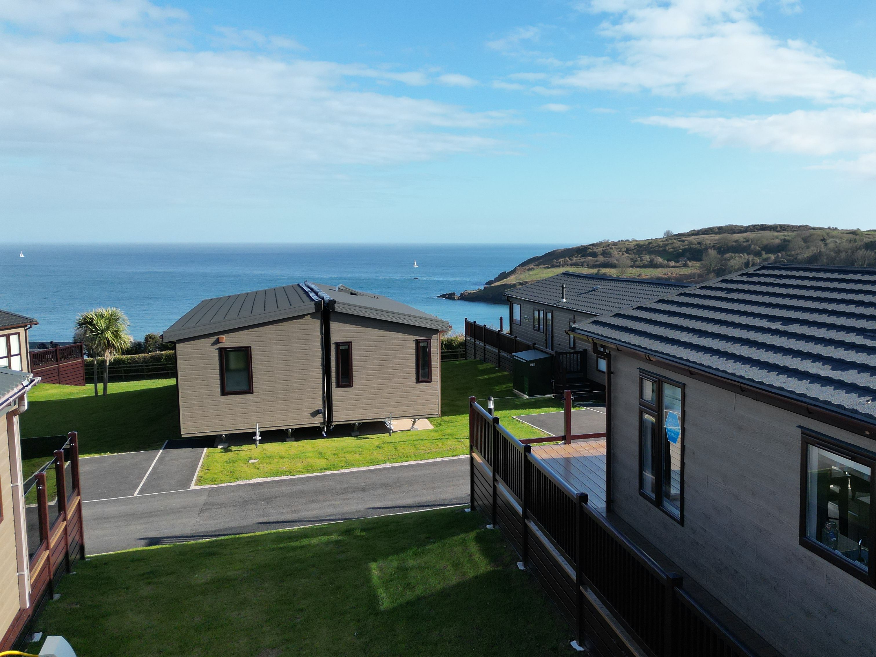 Coastal holiday lodges overlooking the sea on a sunny day