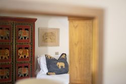 A bedroom with decorative furniture and decor featuring elephant motifs.