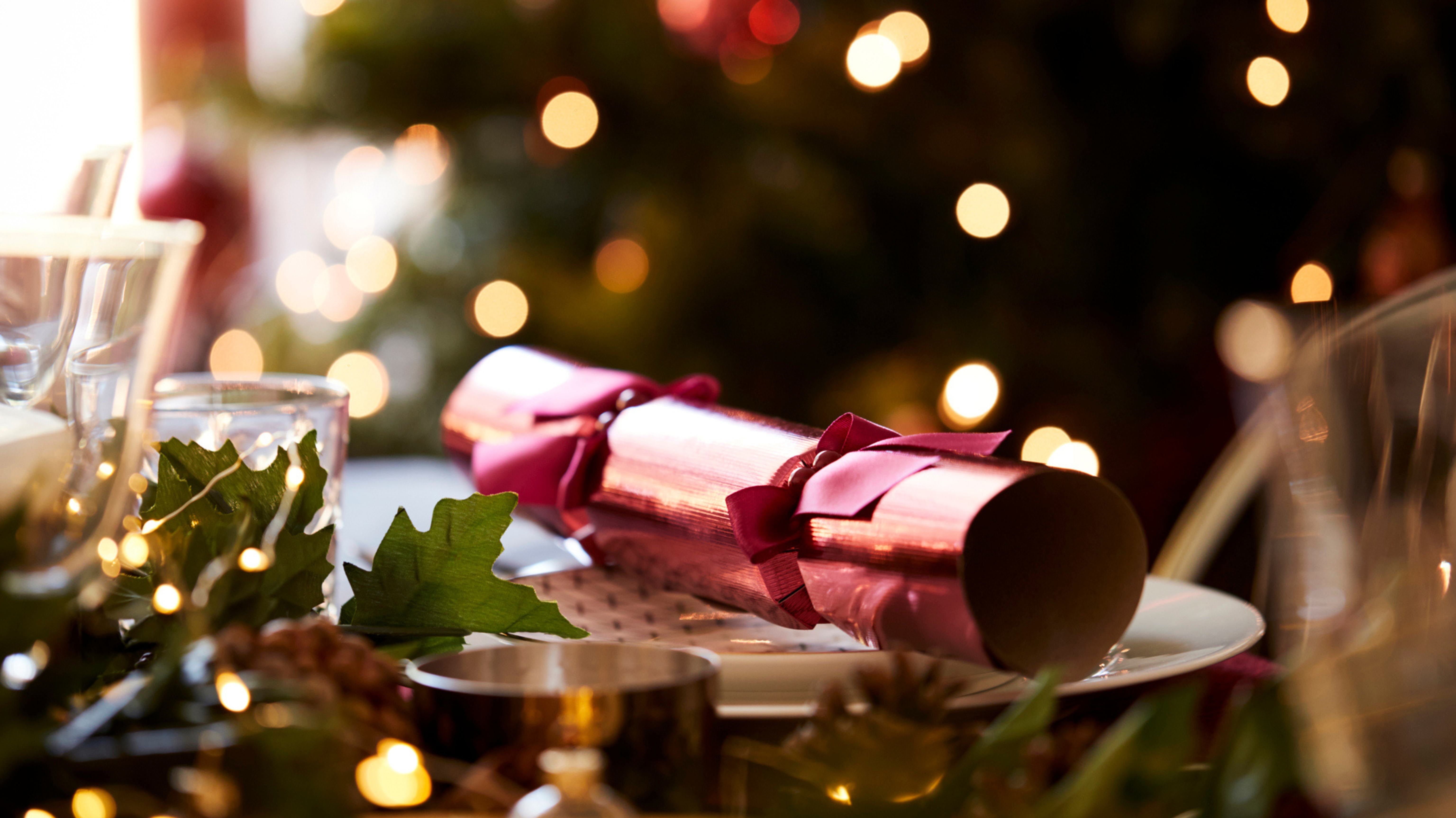 Christmas table setting with festive decorations and a Christmas cracker