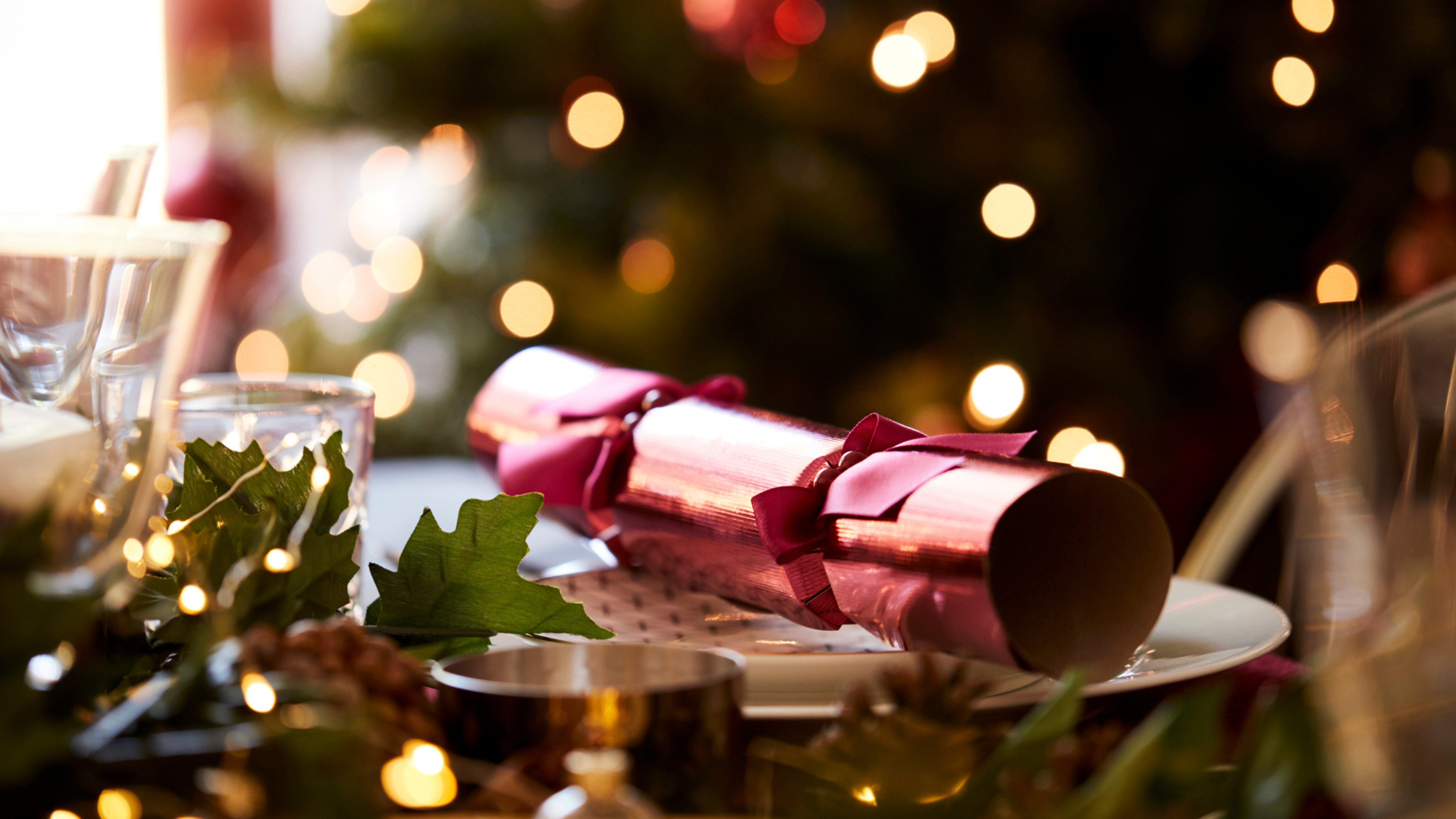 Christmas table setting with festive decorations and a Christmas cracker