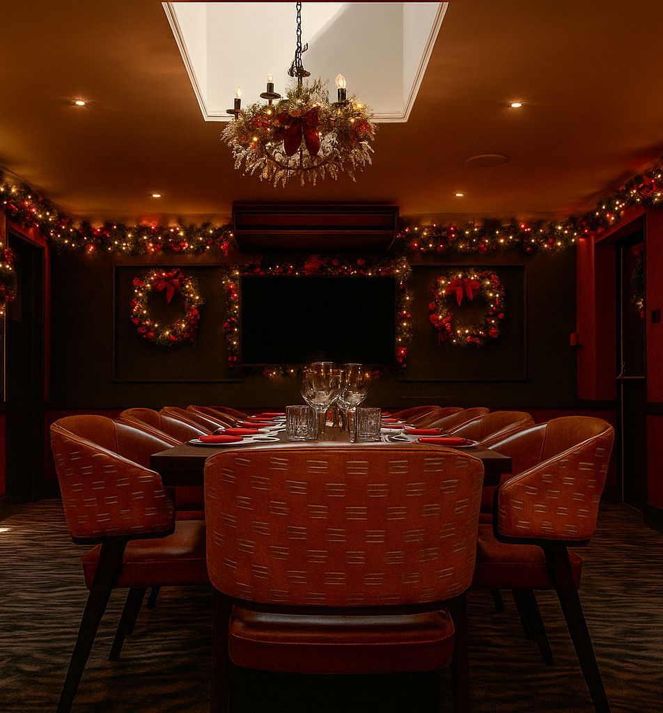 Elegant dining room decorated with Christmas lights, wreaths, and garlands.