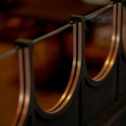Close-up of a decorative wooden and glass partition with curved details.