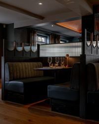 Elegant restaurant booth with set table and dim lighting